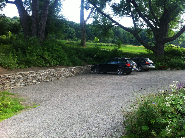 Extended parking area with dry stone retaining wall.